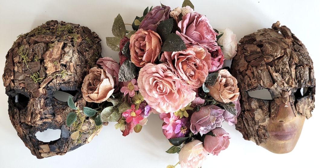 Three masks made by the author, the first and third and covered in tree bark, the second is cover in flowers and cobwebs