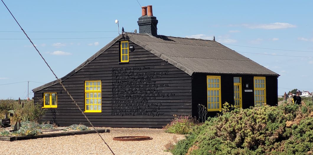 Derek Jarman’s Prospect Cottage, a wooden hut painted with black tar and bright yellow window frames